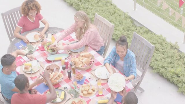 Six adults reaching and serving salad on red-white cloth, animated tags showing sizes for marketing