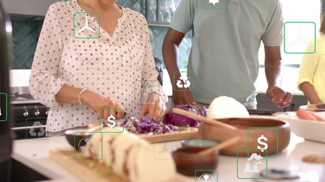Woman starting chopping cabbage, man leaning in, green icons floating around island showing savings