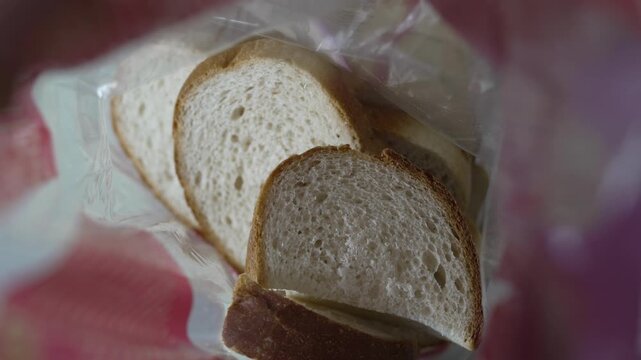  Slices of fresh white bread inside a clear plastic bag