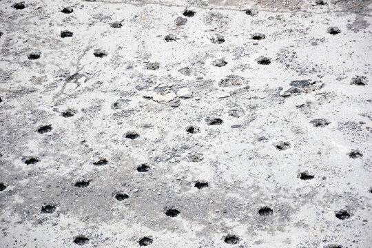 Drilled holes in a concrete surface The Concept of construction