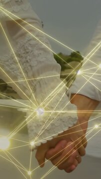 Vertical video: Cam panning, couple holding hands walking, revealing ring, gold net overlaying tech