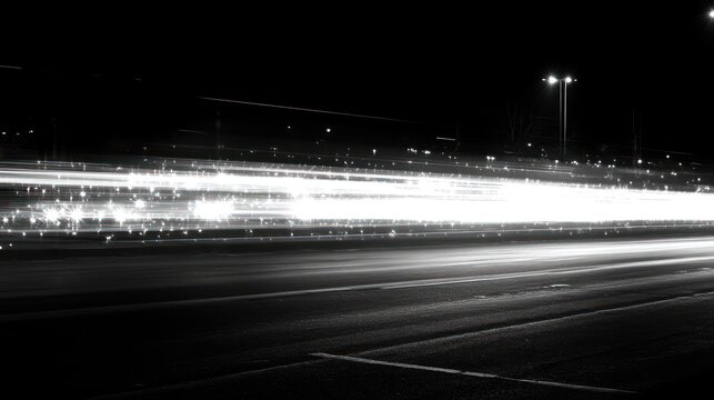 Bright light trails illustrate the energetic flow of vehicles moving swiftly at night