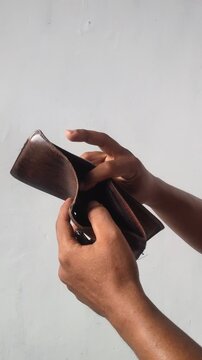 hand holding an empty wallet