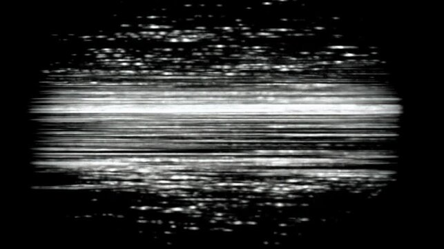 This animation features a stop motion loop showing abstract patterns. The visuals display a mix of light and dark elements. The style emulates analog interference