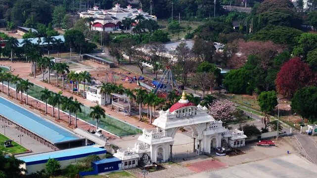 DEPARTMENT OF ARCHAEOLOGY, MUSEUMS building with Food Craft Institute and trees at Dasara Exhibition Ground, Mysuru, karnataka, india. day time, push in shot, drone shot, 4k.