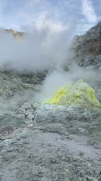 Vertical close-up of volcanic steam rising from Mount Iwo in Hokkaido