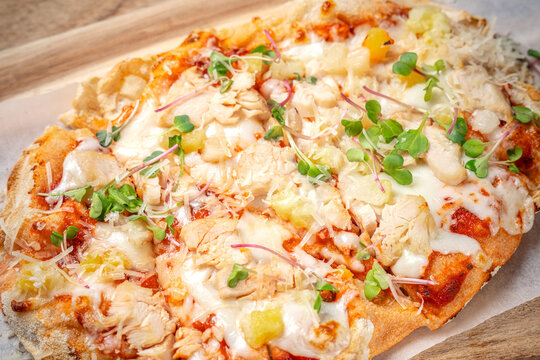 Close up flatbread pizza with chicken pineapple and cheese