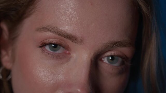 Playful woman winking and smiling in close-up cinematic portrait