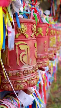 A close-up of red prayer drums khurde . An attribute of Buddhist rituals. Buryatia, Arshan
