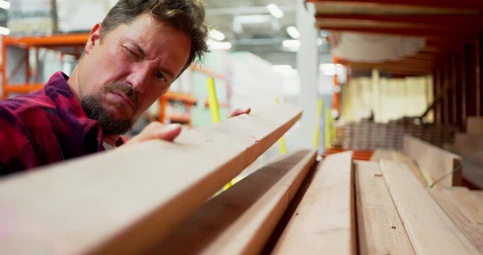 Man Selecting Lumber in a Warehouse Store