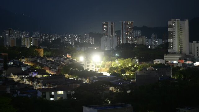 Timelapse video of a cityscape in Floridablanca, Santander, Colombia during nighttime as mist engulfs the urban area while a thunderstorm develops and gradually fades. The scene captures lightning fla