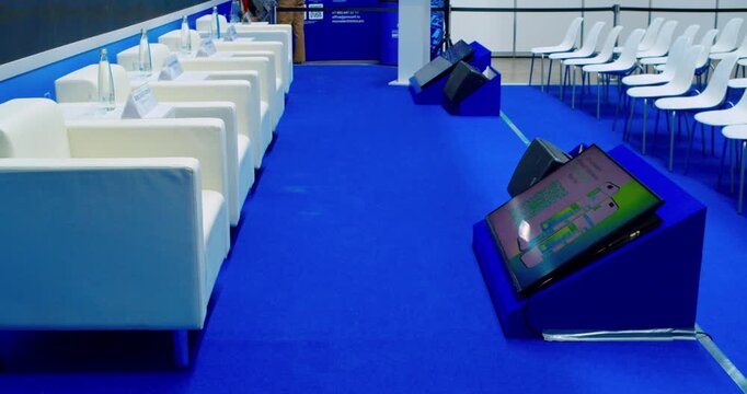 Empty modern conference hall with chairs arranged in a spacious bright room.