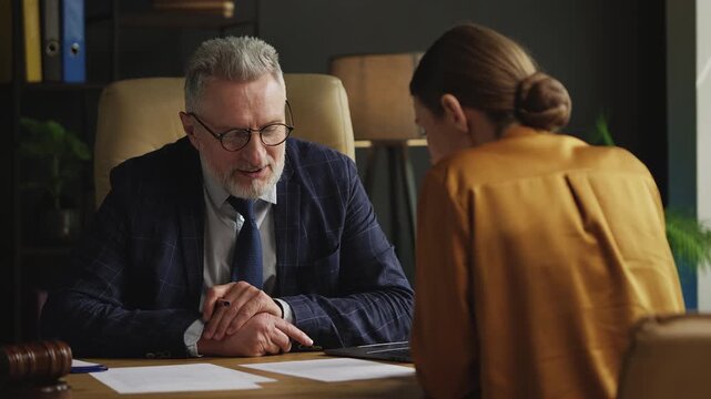 Professional male attorney counseling young woman on a legal case in office