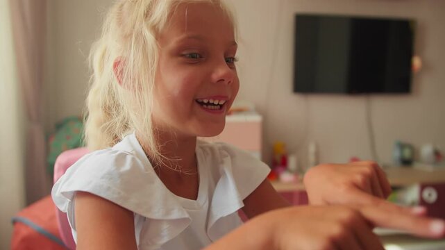Preschool girl looks tired while working on homework at home. School preparation under pressure and responsibility