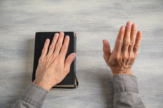 Man taking oath with hand on book.