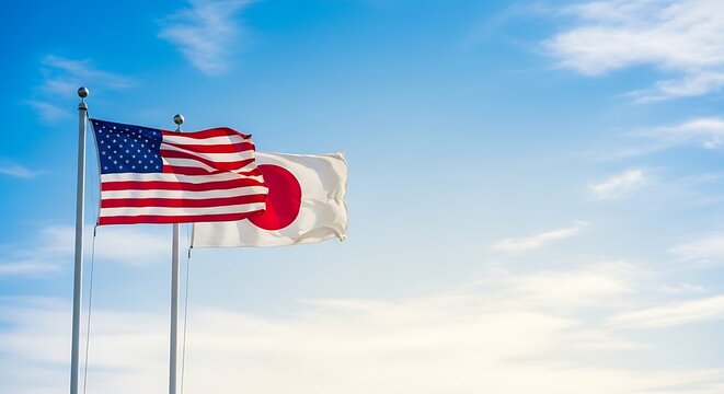 American and Japanese flags waving together on flagpoles against a blue sky with clouds on 4th of July usa background