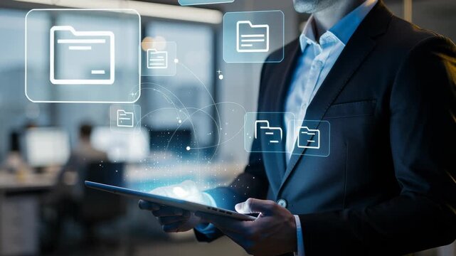 Businessman using digital tablet with floating folder icons in modern office technology concept