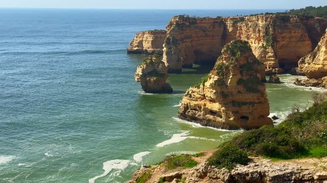 Slide view over empty Pinhao Beach in Lagos Coastline, Algarve, Portugal Aerial wide slide overview shot