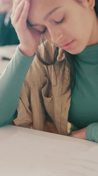 Stress, thinking and test with student in classroom for academic pressure, tired and fail. Frustrated, mistake and worry with girl in high school for assessment, english exam paper and education