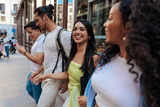Diverse friends enjoying city walk and conversation