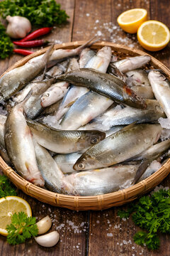 Fresh Raw Fish in Basket with Lemon and Herbs