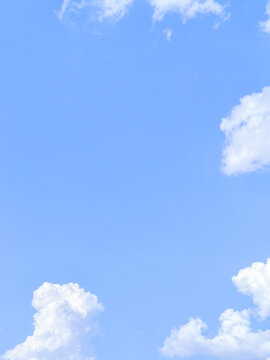 Fluffy White Cumulus Clouds in Clear Blue Sky Background