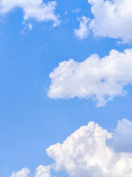 Fluffy White Cumulus Clouds in Clear Blue Sky Background