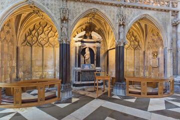 An ornate Gothic cathedral interior features detailed arches, dark columns, a central monument, and a distinctive black and white patterned floor in Beverley Minster - Yorkshire - Great Britain © Robert