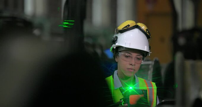 A locomotive engineer in a factory setting uses a laser measuring tool, demonstrating the precision and technical skills required in industrial engineering and construction environments.
