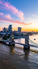 Obraz premium A stunning cityscape at sunset featuring a suspension bridge over a river