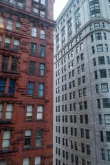 Fototapeta premium Views of Historic Buildings on a Street in Downtown Pittsburgh During the Day With Contrasting Architecture Styles
