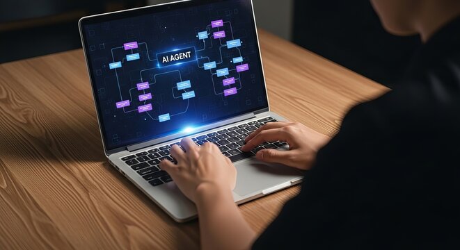 Person using laptop with artificial intelligence agent flowchart on the screen