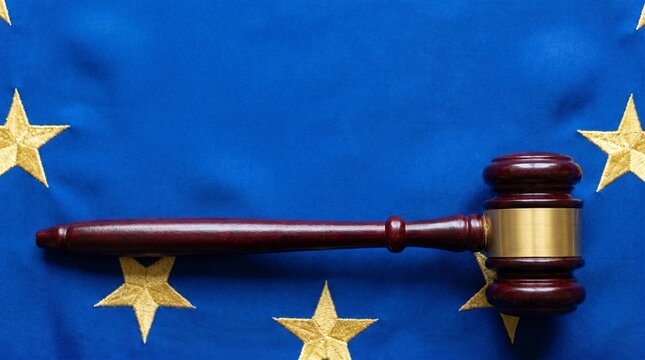 Symbolic representation of European Union law and justice, featuring a judge's gavel placed strategically on the EU flag, signifying legal authority and policy-making within the continent