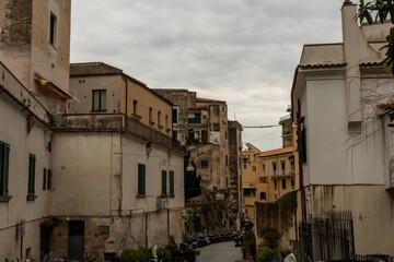 Obraz premium Scenic inland Amalfi town street in springtime under heavily overcast sky, Amalfi Coast, Campania, Southern Italy