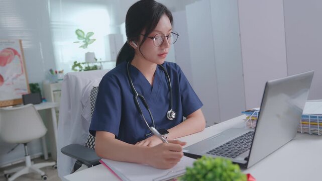 A female doctor note in book at a white wooden desk in her hospital office. illustrating diagnoses and recording patient symptoms. Healthcare and medicine. Physician  diagnosis and treatment plan.