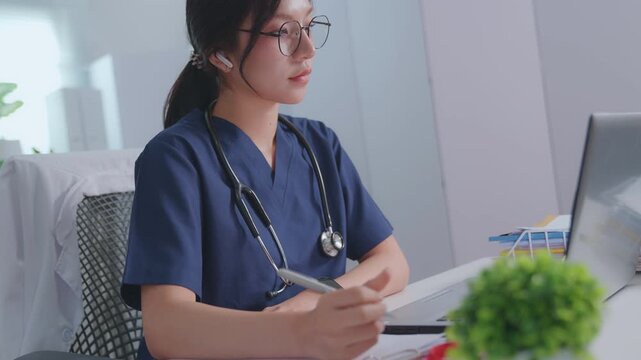 A female doctor note in book at a white wooden desk in her hospital office. illustrating diagnoses and recording patient symptoms. Healthcare and medicine. Physician  diagnosis and treatment plan.