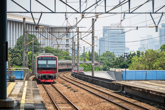 A local commuter train, in Jakarta, Indonesia, arriving at the station