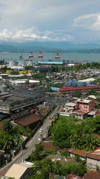 Villages and commercial buildings in City of Cagayan de Oro. Blue sky and clouds. Mindanao, Philippines. Vertical video.