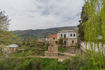 Fototapeta premium Traditional stone mansion with garden and panoramic mountain view in Makrinitsa village, Pelion, Greece