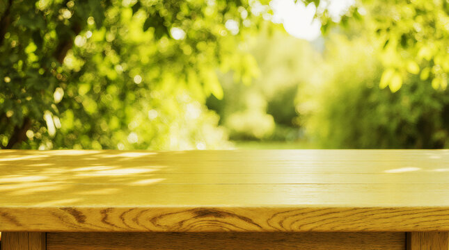 Empty wooden tabletop with soft blurred green garden background and sunlight. Perfect natural backdrop with copy space for product display, advertising, branding or eco lifestyle concepts.