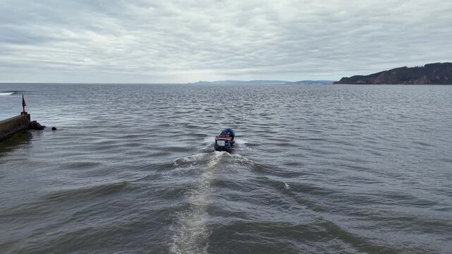 Artisanal fishing boat departing to the Pacific Ocean in Lebu, Chile.
