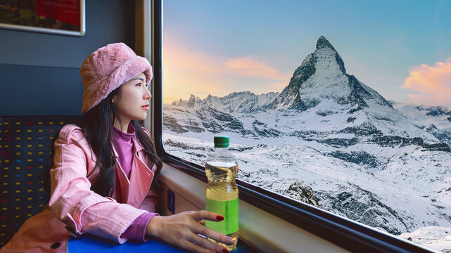 Tourist looking out the window enjoying with the Matterhorn mountain while sitting in the train, Zermatt in Switzerland.