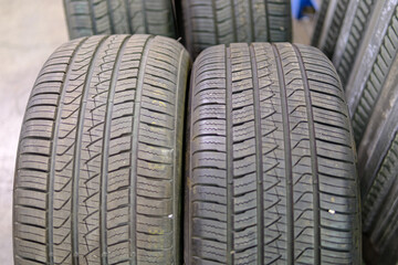 Obraz premium Vehicle tires with tread closeup in storage