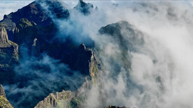 High altitude mountain landscape with moving clouds near Pico do Arieiro, Madeira