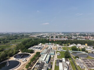 Fototapeta premium Aerial View of Wastewater Treatment Facility: An expansive aerial perspective captures a wastewater treatment facility amidst nature.