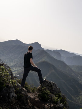 man on top of rock looking over Teno Mountains in Tenerife 