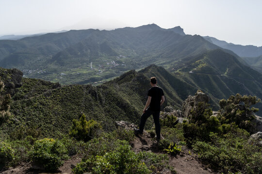 man on top of rock looking over Teno Mountains in Tenerife 