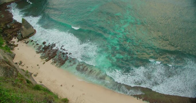 Beautiful Sandy Shoreline and Pointed Rock Formation at Diamond Beach in Nusa Penida Bali