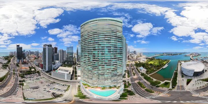 Flying between skyscrapers in the city. 8k aerial 360 miami footage
