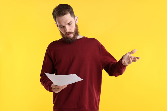 Professional actor with script performing on yellow background
